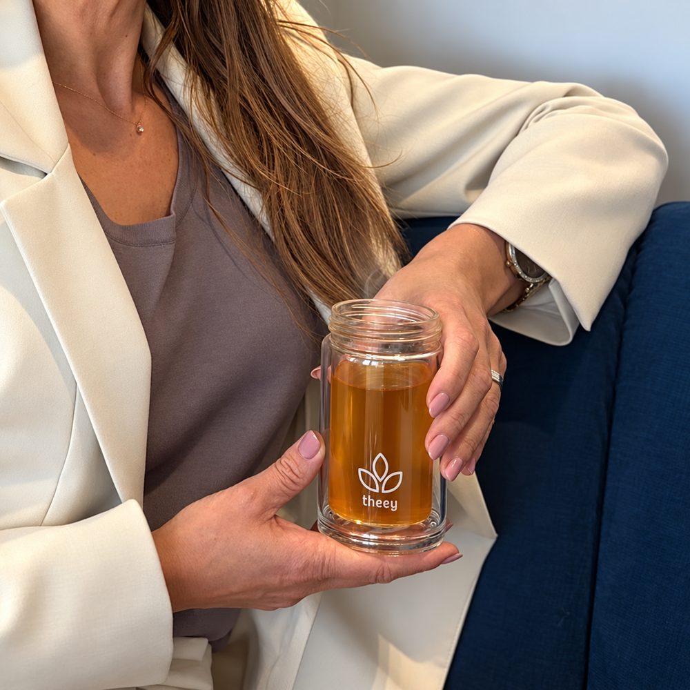 Handen om het Theey-glas met gemberthee